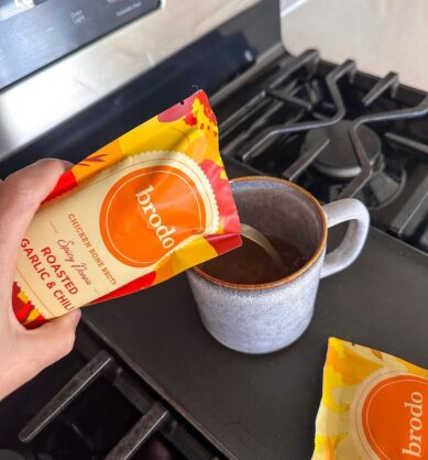 Influencer pouring Brodo bone broth into a mug