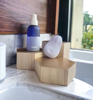 Influencer photo of Dame products posed on a wooden shelf