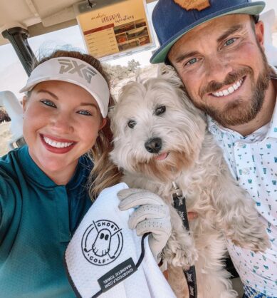 Influencers @drivechipandpup pose with their dog and Ghost Golf magnetic golf towel