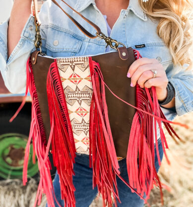 Influencer poses with Jill's Homestead Dolly Double Fringe bag with red fringe