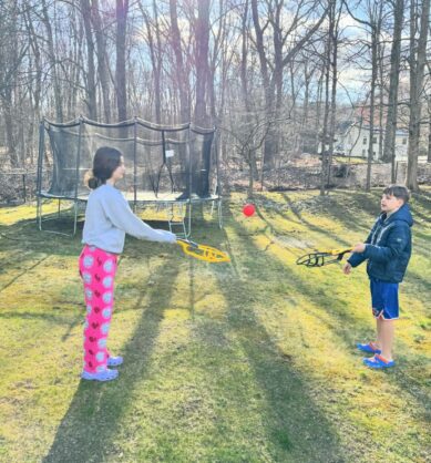 Children of family influencer playing with Wham-O Trac-Ball toys