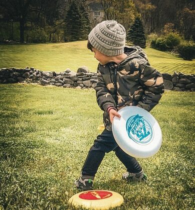 Child of family influencer playing with Wham-O Frisbee