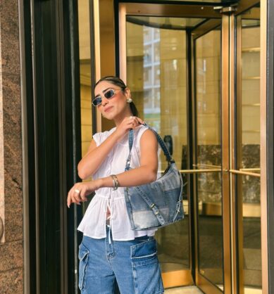 Influencer posing with Patricia Nash Healey Pouch Washed Denim Patchwork bag