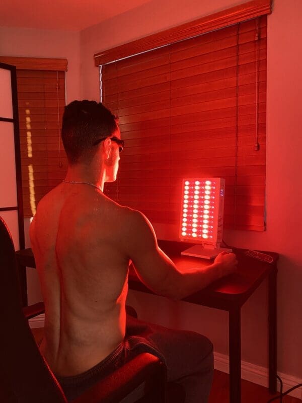 Guy sitting in front of red light