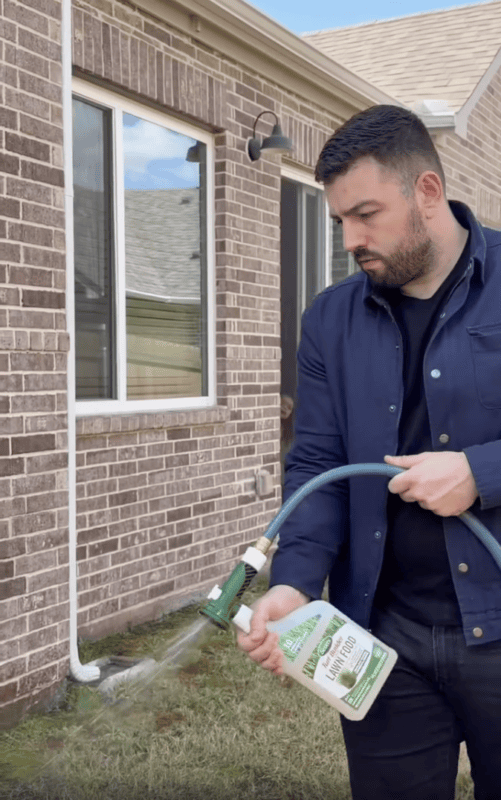 Person spraying product in yard