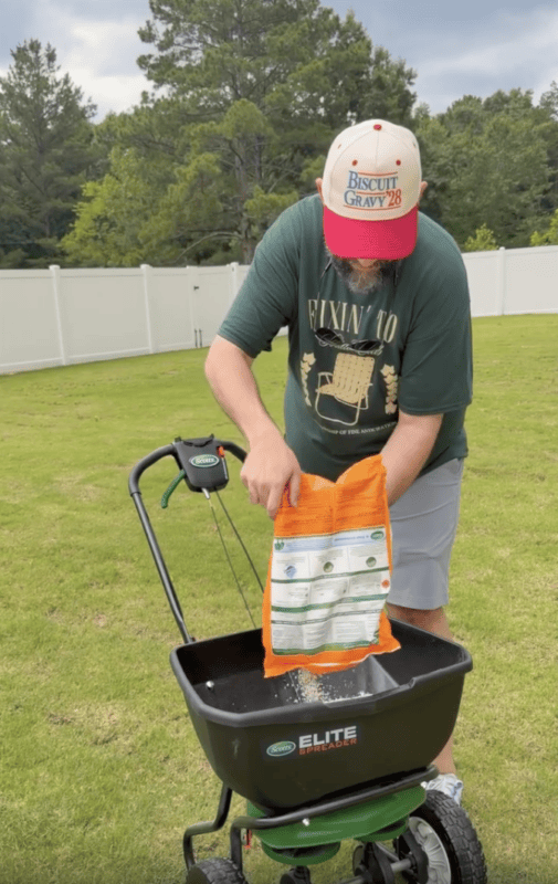 man fixing yard with turf builder